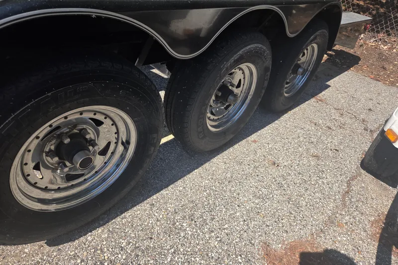 Slide: The Image of Trailer wheels of a 2006 Sea Ray 290 Select EX boat on pavement. - 14