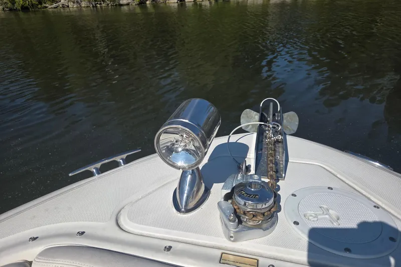 Slide: The Image of Bow of 2006 Sea Ray 290 Select EX with anchor and spotlight on calm water. - 17