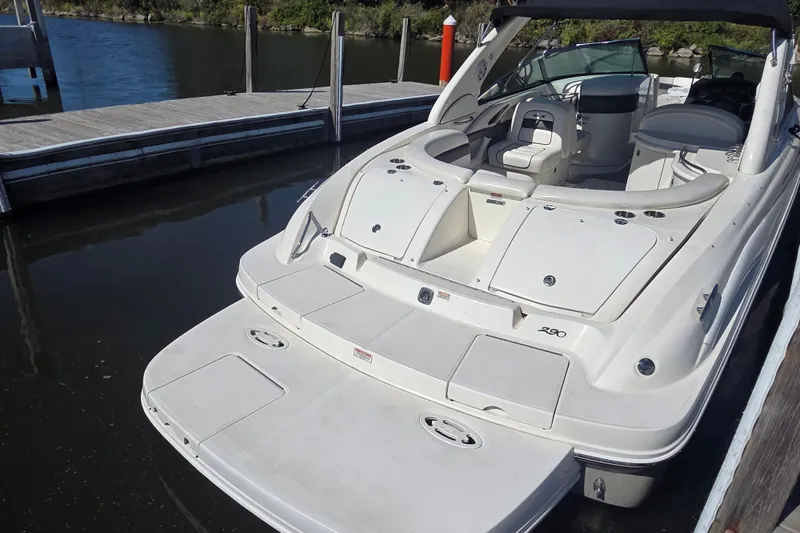 Slide: The Image of 2006 Sea Ray 290 Select EX boat docked at marina, rear view. - 2