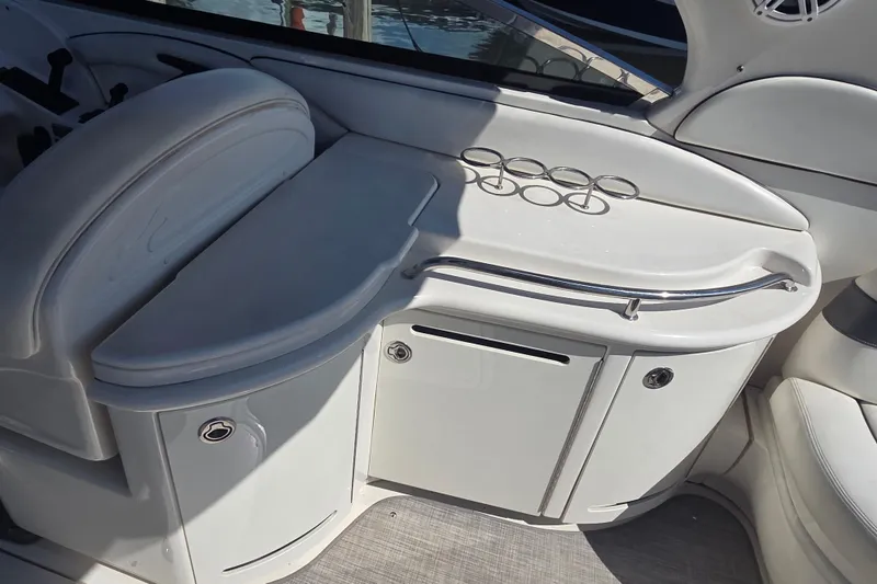 Slide: The Image of Interior of 2006 Sea Ray 290 Select EX boat with cup holders and storage. - 26