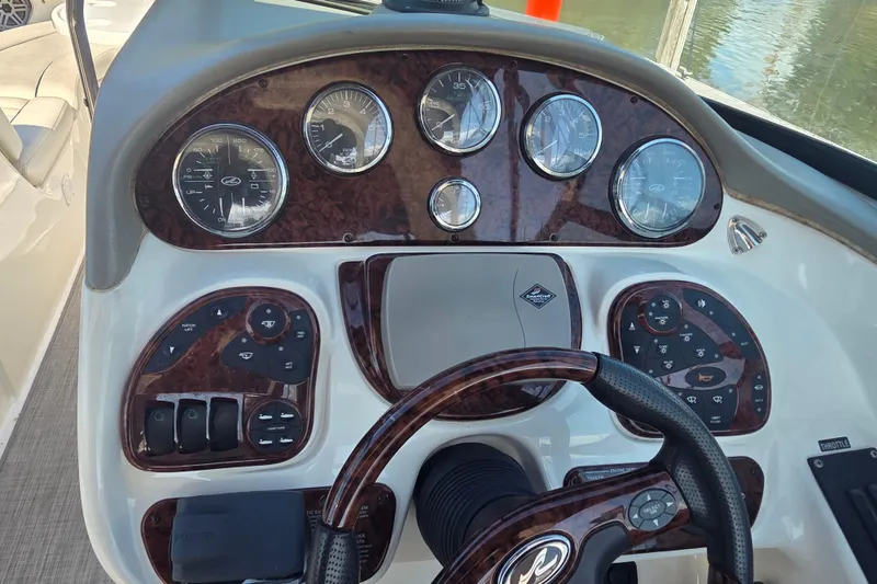 Slide: The Image of Dashboard of a 2006 Sea Ray 290 Select EX boat with gauges and controls. - 28