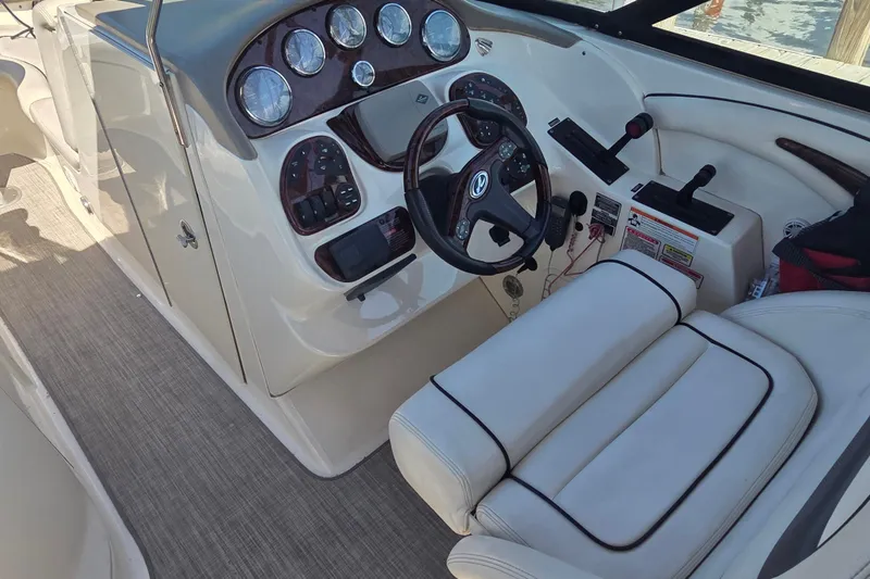 Slide: The Image of 2006 Sea Ray 290 Select EX boat cockpit with steering wheel and control panel. - 35