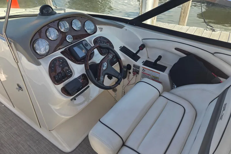 Slide: The Image of 2006 Sea Ray 290 Select EX boat dashboard with gauges and steering wheel. - 4