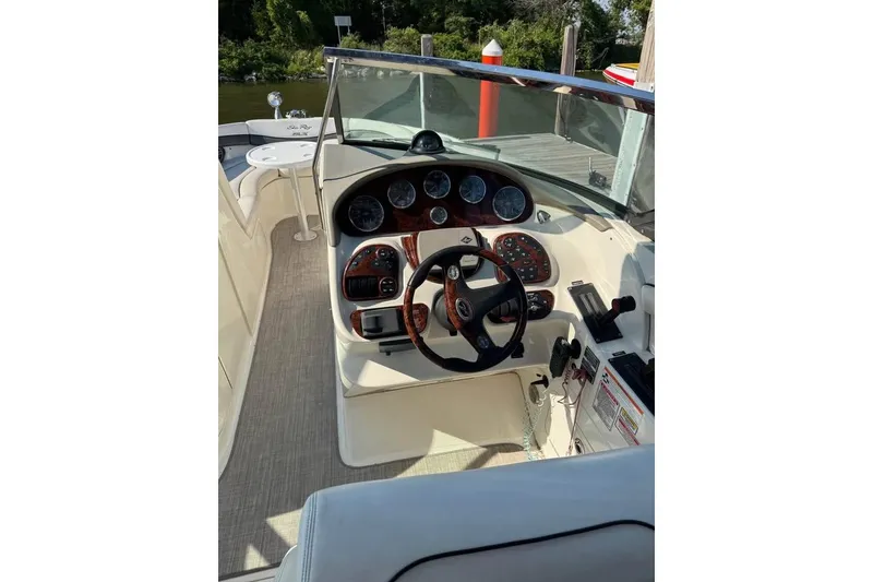 Slide: The Image of 2006 Sea Ray 290 Select EX boat cockpit with steering wheel and control panel. - 5