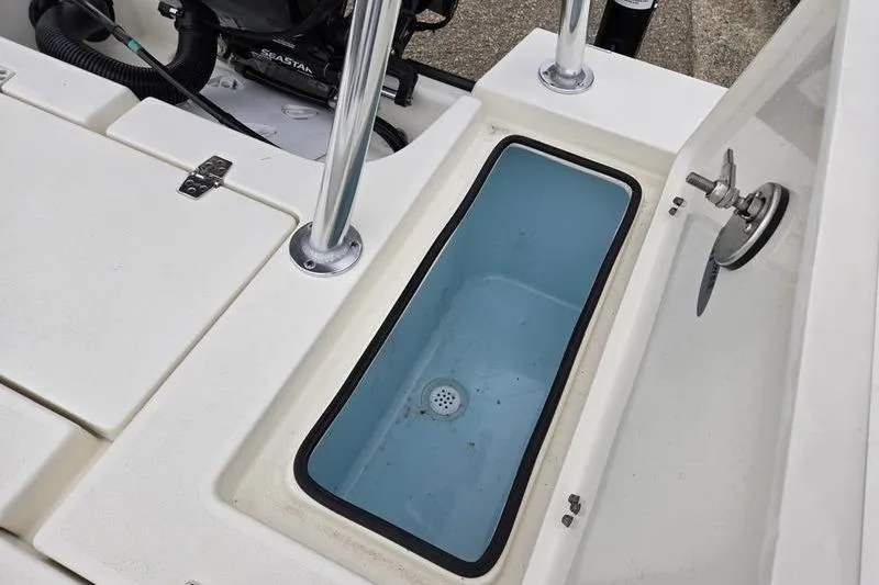 Slide: The Image of 2025 Hewes 16 Redfisher boat interior with open storage compartment. - 10