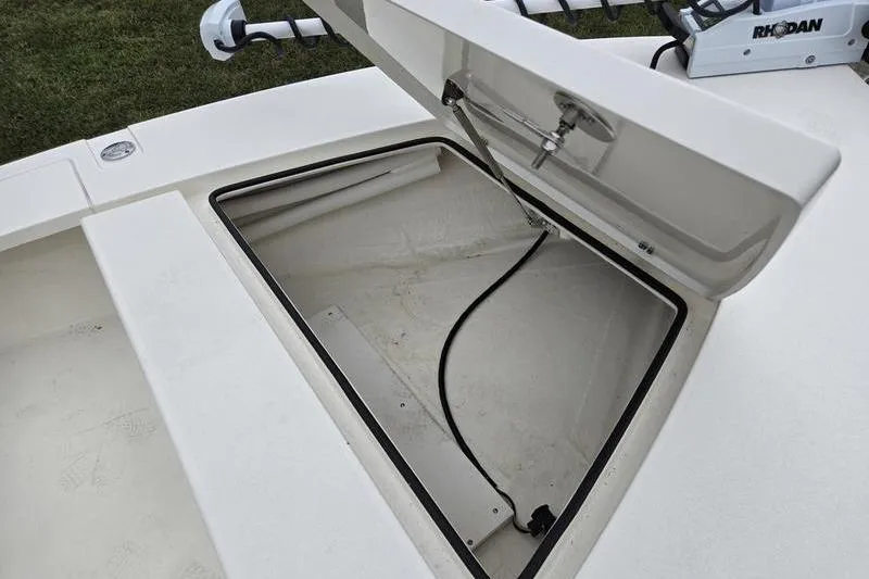 Slide: The Image of Open storage compartment on 2025 Hewes 16 Redfisher boat, showcasing interior space. - 4