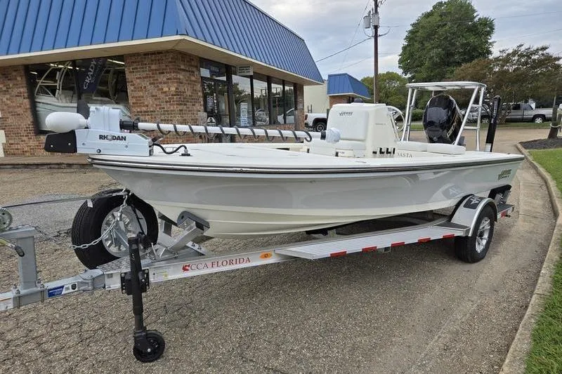 Slide: The Image of 2025 Hewes 16 Redfisher boat on trailer outside dealership. - 5
