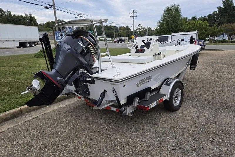 Slide: The Image of 2025 Hewes 16 Redfisher boat on trailer with Yamaha outboard motor. - 6