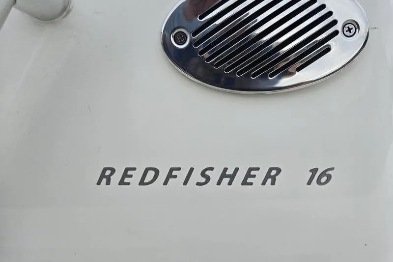 Slide: The Image of 2025 Hewes 16 Redfisher boat emblem with chrome vent detail. - 7