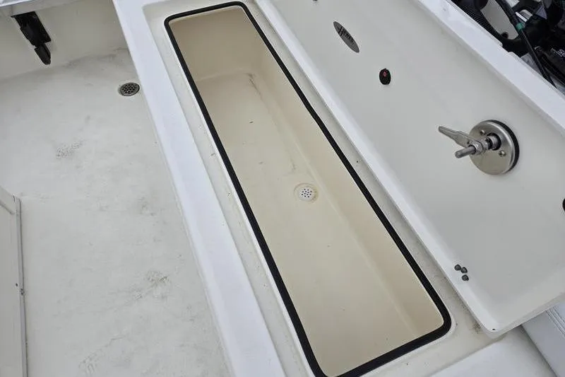 Slide: The Image of 2025 Hewes 16 Redfisher boat interior with open storage compartment. - 8