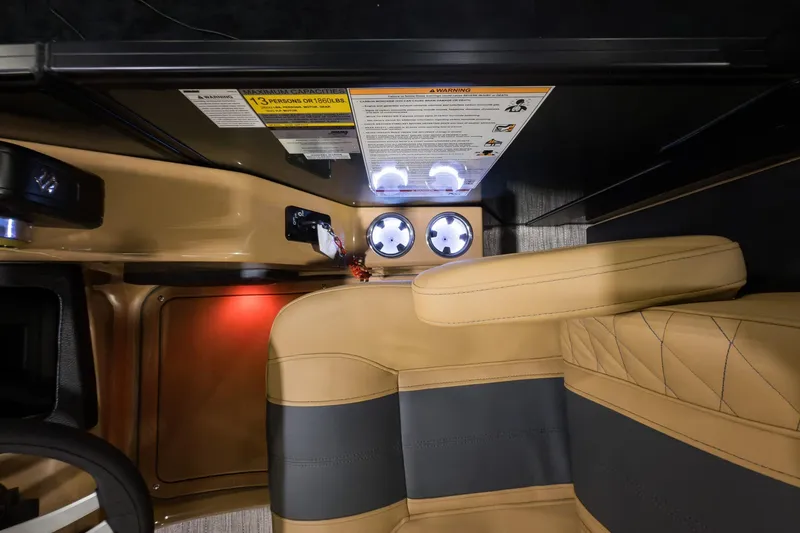 Slide: The Image of Interior of 2026 Godfrey Monaco 235 Split Bench with illuminated cup holders and beige seating. - 10