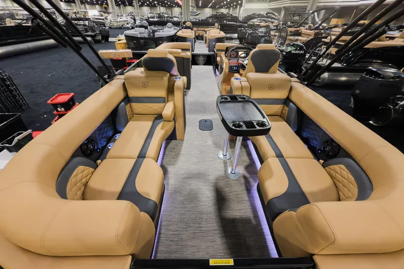 Slide: The Image of 2026 Godfrey Monaco 235 Split Bench boat interior with luxurious tan seating and modern amenities. - 13