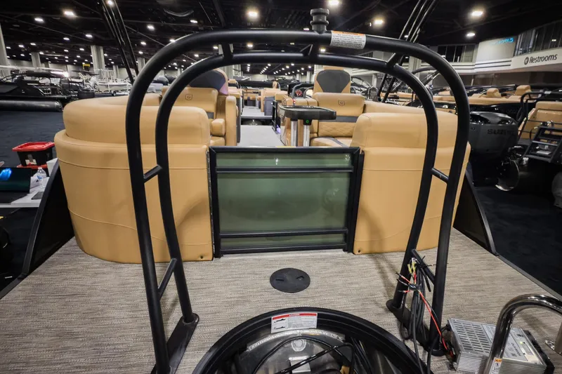 Slide: The Image of 2026 Godfrey Monaco 235 Split Bench boat interior at a showroom display. - 19