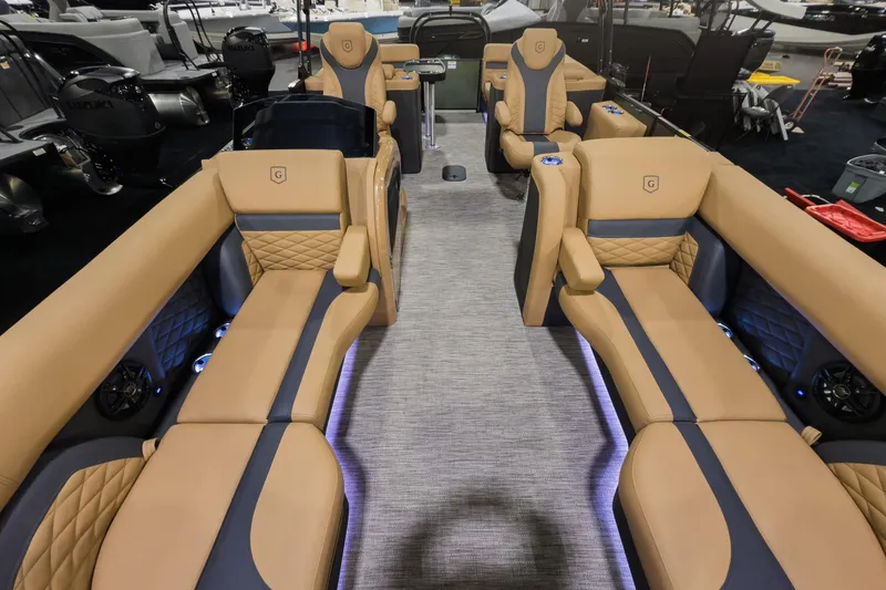 Slide: The Image of Luxurious interior of 2026 Godfrey Monaco 235 Split Bench pontoon boat with tan seating. - 2
