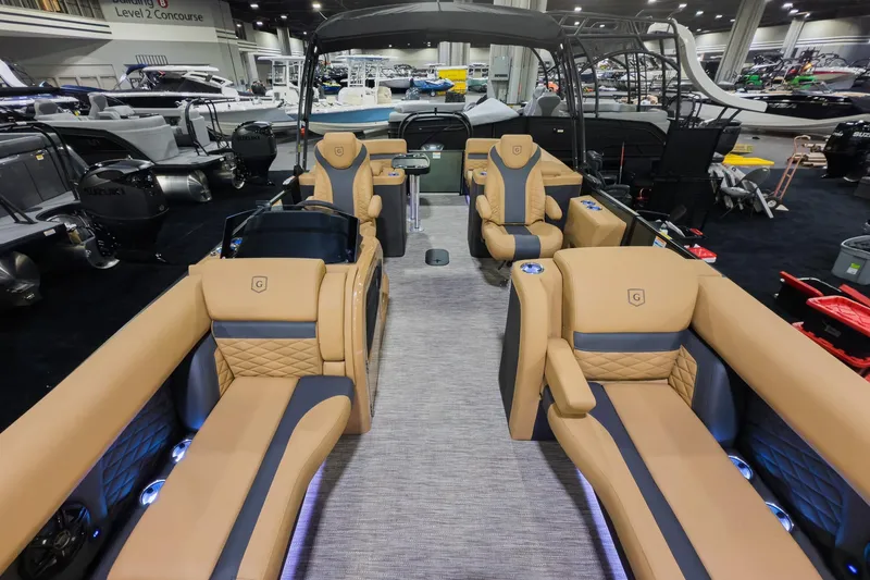 Slide: The Image of 2026 Godfrey Monaco 235 Split Bench boat interior with luxurious tan seating and modern design. - 3