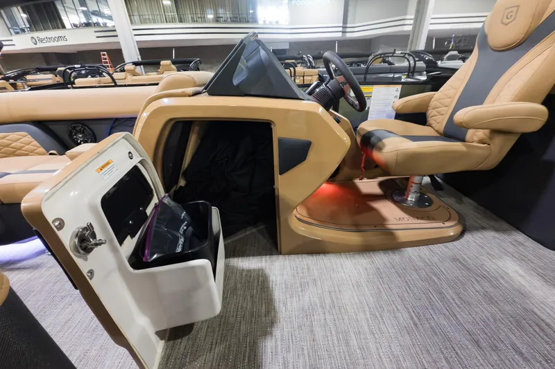 Slide: The Image of 2026 Godfrey Monaco 235 Split Bench interior with captain's chair and storage compartment. - 8