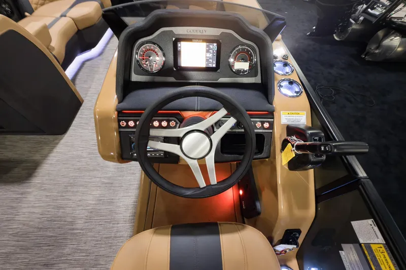 Slide: The Image of 2026 Godfrey Monaco 235 Split Bench dashboard with steering wheel and control panel. - 9