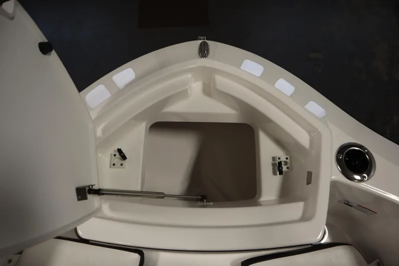 Slide: The Image of 2026 Yamaha Boats 255 FSH Sport E storage compartment, open and empty. - 12