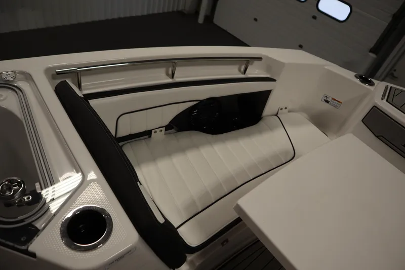 Slide: The Image of 2026 Yamaha Boats 255 FSH Sport E interior seating with sleek white upholstery. - 13