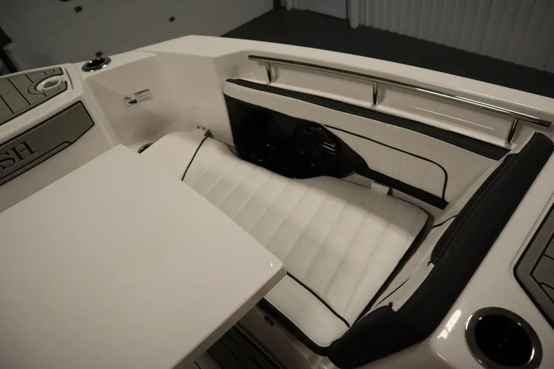 Slide: The Image of 2026 Yamaha Boats 255 FSH Sport E interior with white cushioned seating and sleek design. - 14