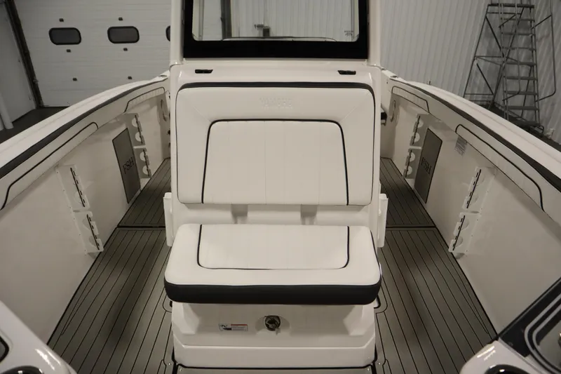 Slide: The Image of 2026 Yamaha Boats 255 FSH Sport E interior with white seating and sleek design. - 18