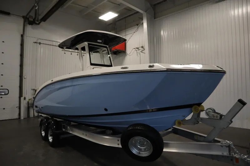Slide: The Image of 2026 Yamaha Boats 255 FSH Sport E in indoor showroom, side view. - 2
