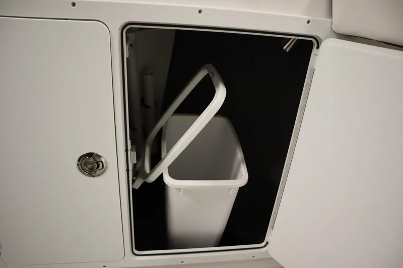 Slide: The Image of Yamaha Boats 2026 255 FSH Sport E storage compartment with trash bin. - 21