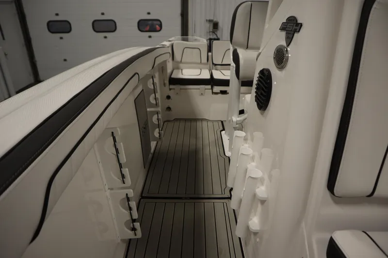 Slide: The Image of 2026 Yamaha Boats 255 FSH Sport E interior with rod holders and seating. - 24