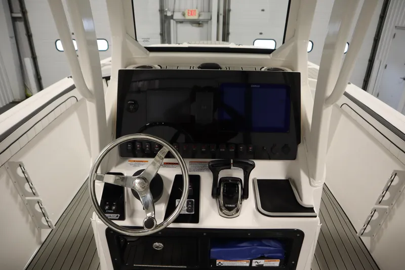 Slide: The Image of 2026 Yamaha Boats 255 FSH Sport E dashboard with steering wheel and controls. - 26