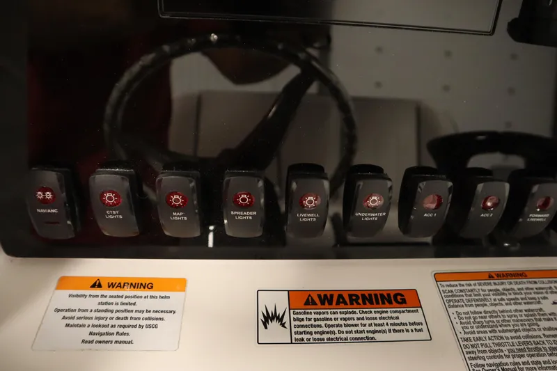 Slide: The Image of Control panel of 2026 Yamaha Boats 255 FSH Sport E with labeled switches and warning labels. - 30