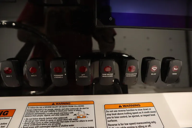 Slide: The Image of Control panel of 2026 Yamaha Boats 255 FSH Sport E with labeled switches and warnings. - 31