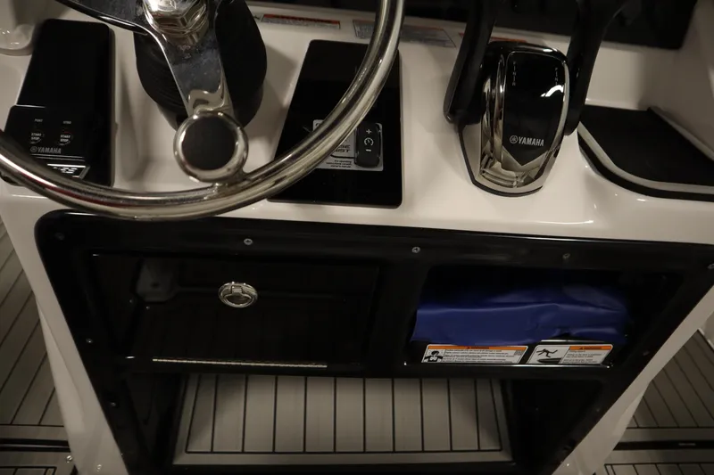 Slide: The Image of 2026 Yamaha Boats 255 FSH Sport E helm with steering wheel and controls. - 34