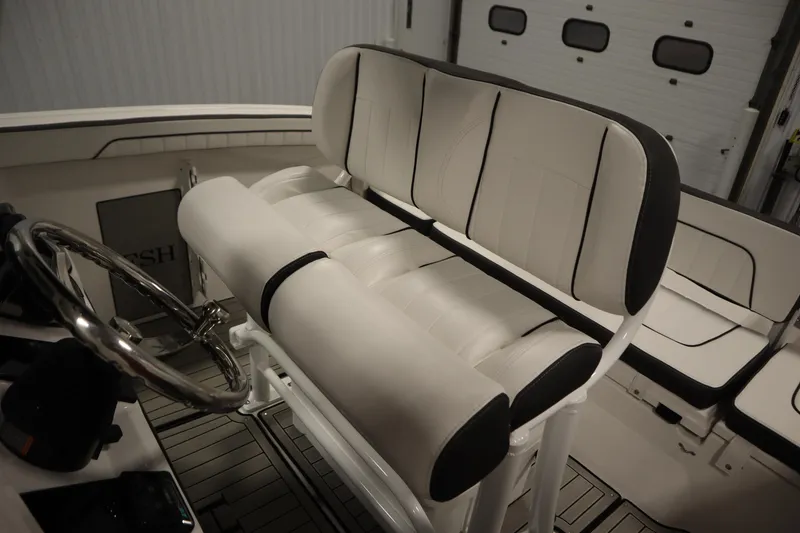 Slide: The Image of 2026 Yamaha Boats 255 FSH Sport E interior with sleek seating and steering wheel. - 35