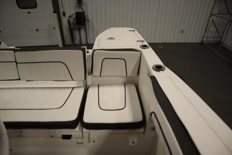 Slide: The Image of 2026 Yamaha Boats 255 FSH Sport E interior seating with white cushions and black trim. - 37