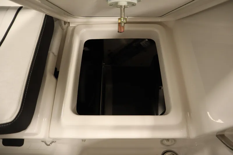 Slide: The Image of 2026 Yamaha Boats 255 FSH Sport E storage compartment with cushioned seating detail. - 38