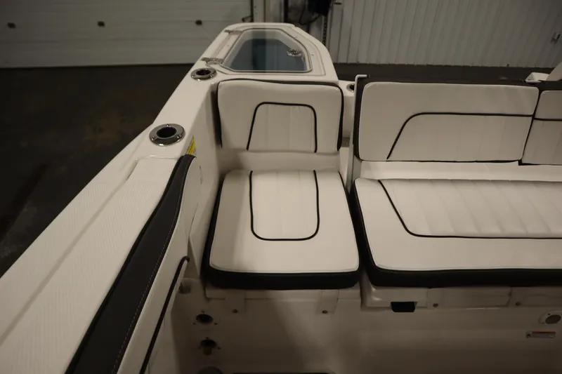 Slide: The Image of 2026 Yamaha Boats 255 FSH Sport E interior seating with sleek white upholstery. - 39