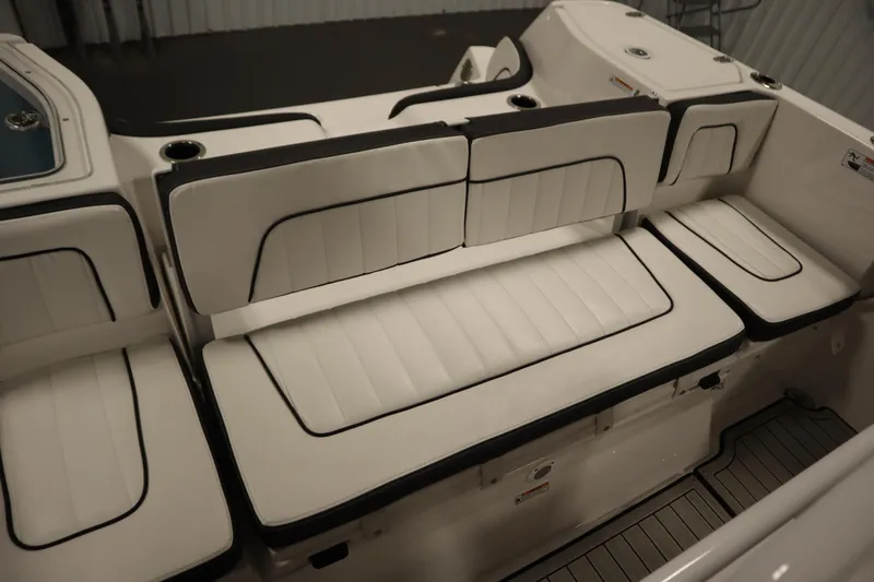 Slide: The Image of 2026 Yamaha Boats 255 FSH Sport E interior seating with white cushioned upholstery. - 40