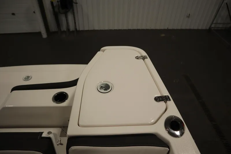 Slide: The Image of 2026 Yamaha Boats 255 FSH Sport E deck detail with storage compartment and cup holders. - 42