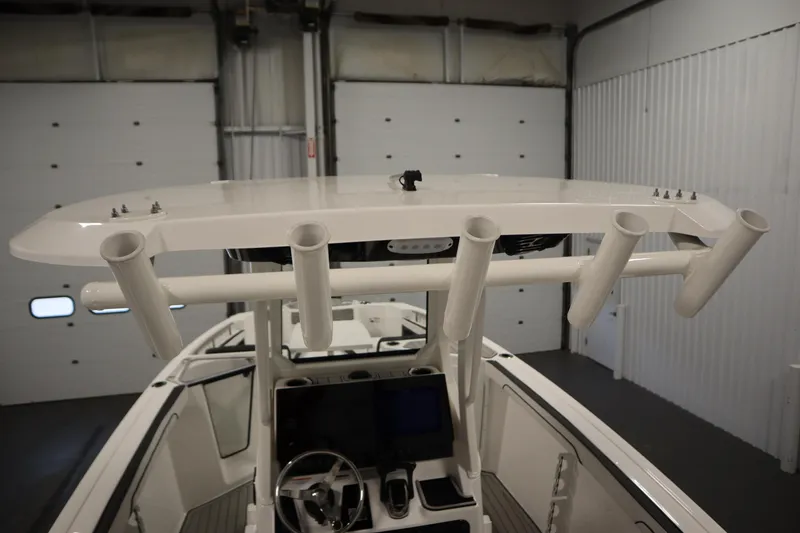 Slide: The Image of 2026 Yamaha Boats 255 FSH Sport E, interior view with rod holders and helm. - 46