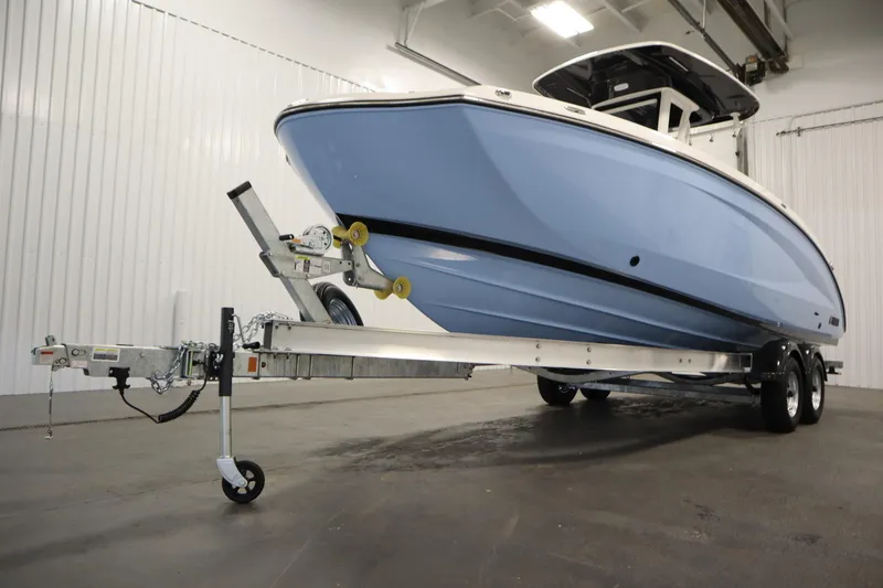 Slide: The Image of 2026 Yamaha Boats 255 FSH Sport E on trailer in indoor setting. - 54