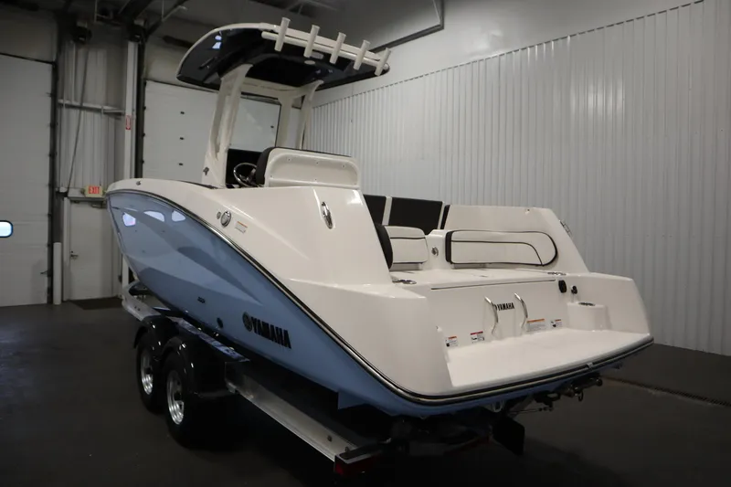 Slide: The Image of 2026 Yamaha Boats 255 FSH Sport E in a showroom, rear view. - 6