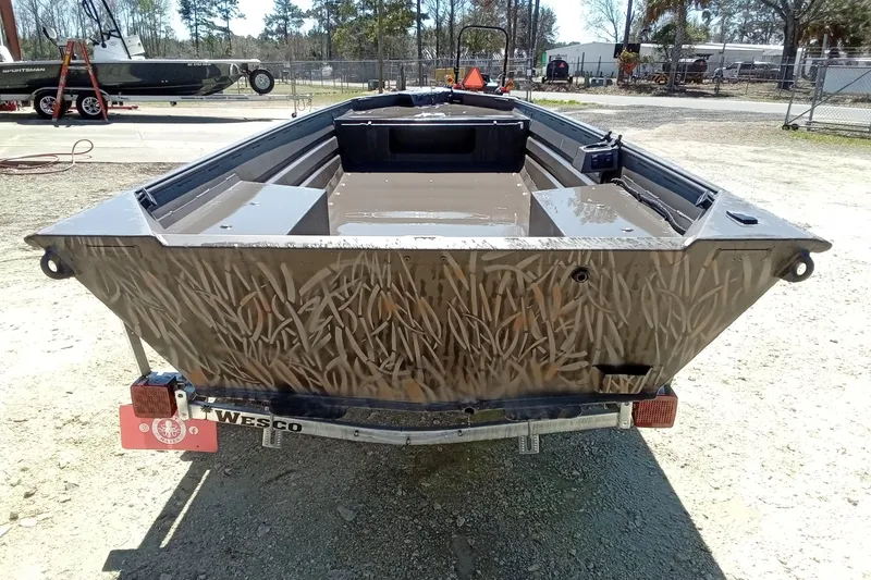 Slide: The Image of 2025 Alweld 1648VV Marsh boat on trailer, camo design, outdoor setting. - 11