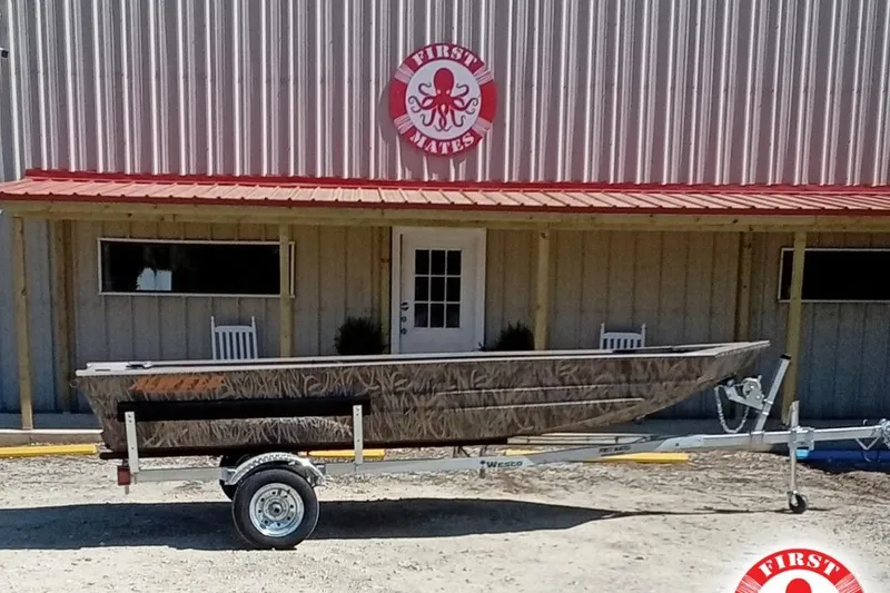 Slide: The Image of 2025 Alweld 1648VV Marsh boat on trailer outside a building with red roof. - 12