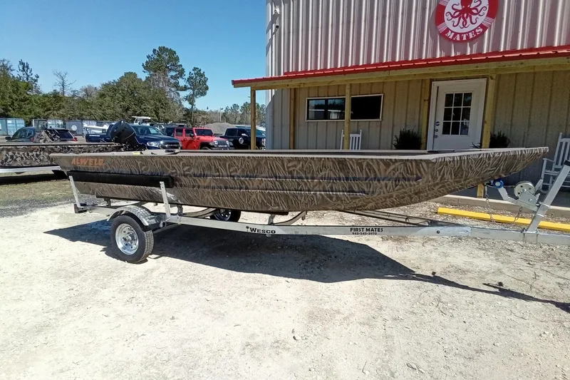 Slide: The Image of 2025 Alweld 1648VV Marsh boat on trailer outside a building. - 14