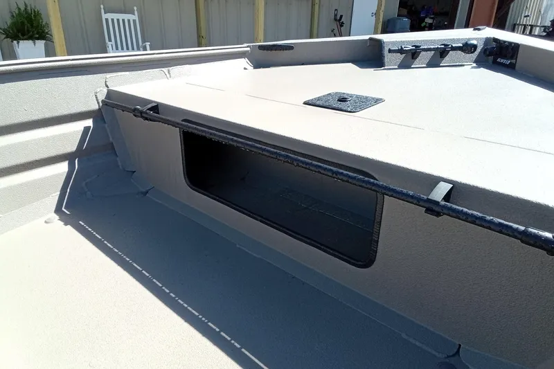 Slide: The Image of 2025 Alweld 1648VV Marsh boat interior with storage compartment and rod holder. - 18