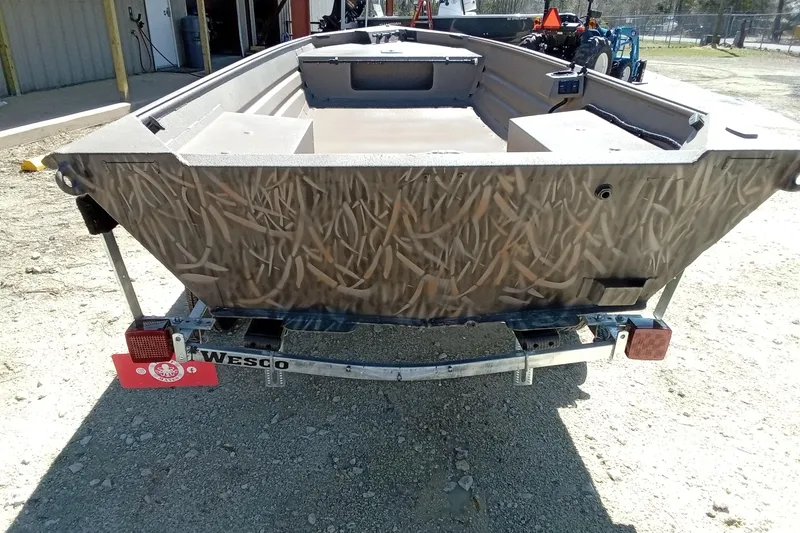 Slide: The Image of 2025 Alweld 1648VV Marsh boat on trailer, featuring camo design. - 21