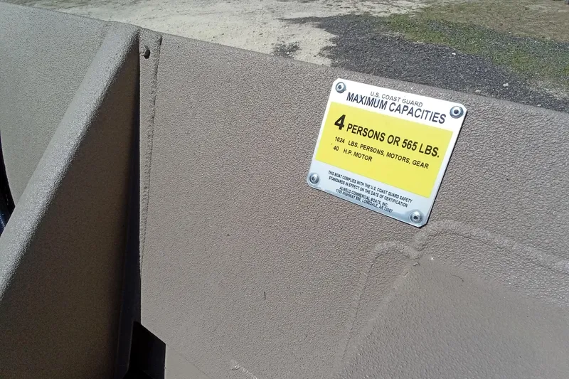 Slide: The Image of 2025 Alweld 1648VV Marsh boat capacity label, 4 persons or 565 lbs limit. - 24