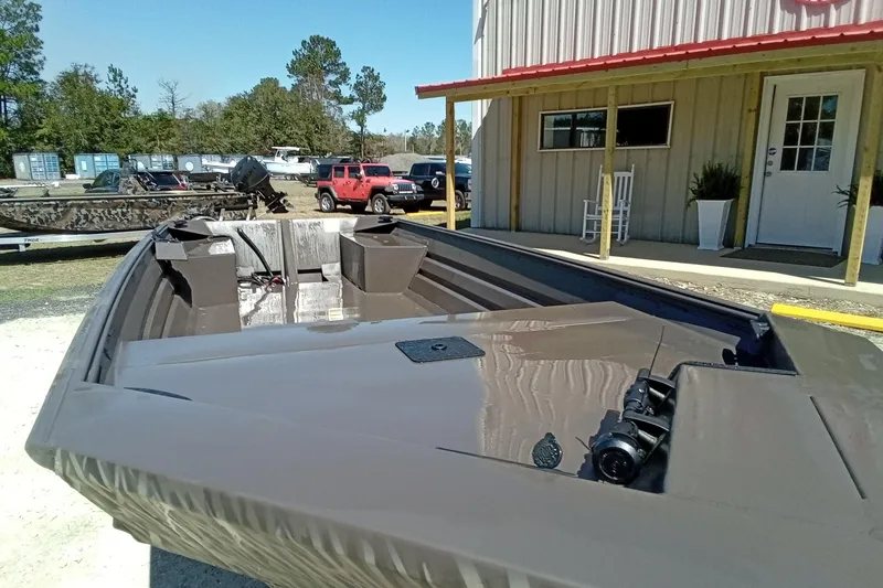 Slide: The Image of 2025 Alweld 1648VV Marsh boat parked outside a building on a sunny day. - 4