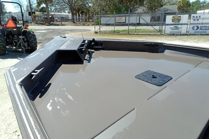 Slide: The Image of 2025 Alweld 1648VV Marsh boat, gray deck, outdoor setting, tractor in background. - 6