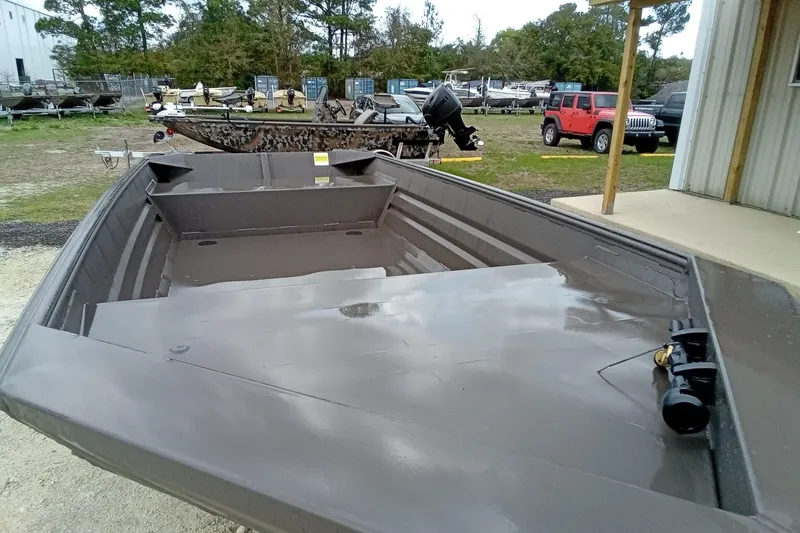 Slide: The Image of 2025 Alweld 1548VV Marsh boat, parked outdoors, showcasing spacious interior and sturdy design. - 5